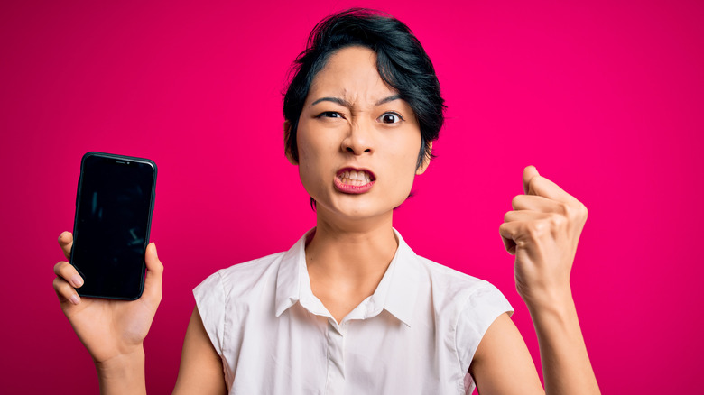 Frustrated woman shaking her fist