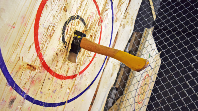 An axe hits a wooden target