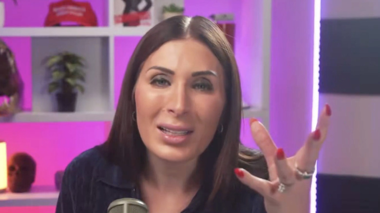 Laura Loomer talking with one hand out on her podcast
