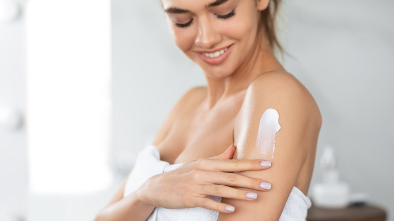 Woman applying lotion