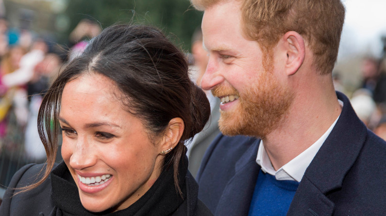 Prince Harry grips Meghan Markle's shoulder