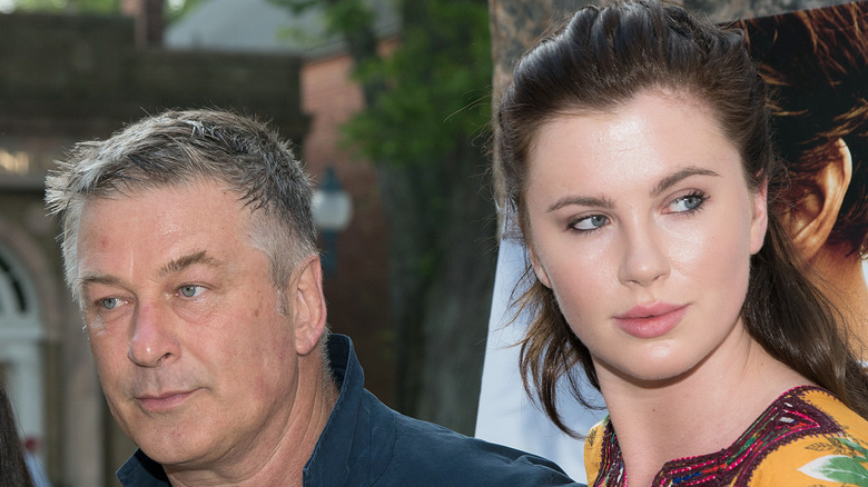 Alec and Ireland Baldwin looking in opposite directions at a movie premiere.