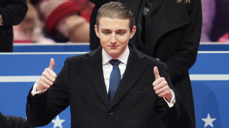 Barron Trump giving a crowd a double thumbs-up