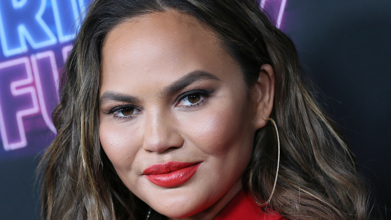 Chrissy Teigen poses on the red carpet