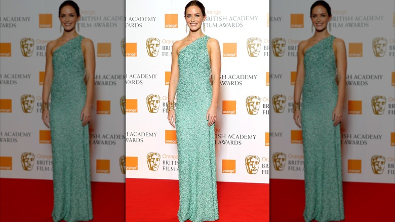 Emily Blunt smiling in a mint-green dress