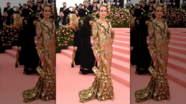 Emily Blunt poses in a shiny gold dress at the Met Gala