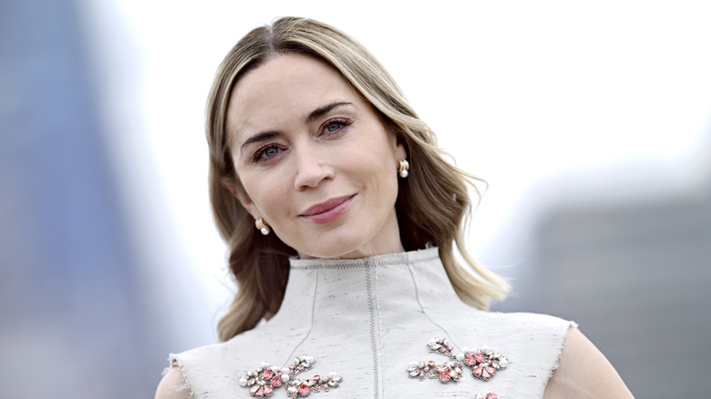 Emily Blunt in a white top embellished with colorful jewels