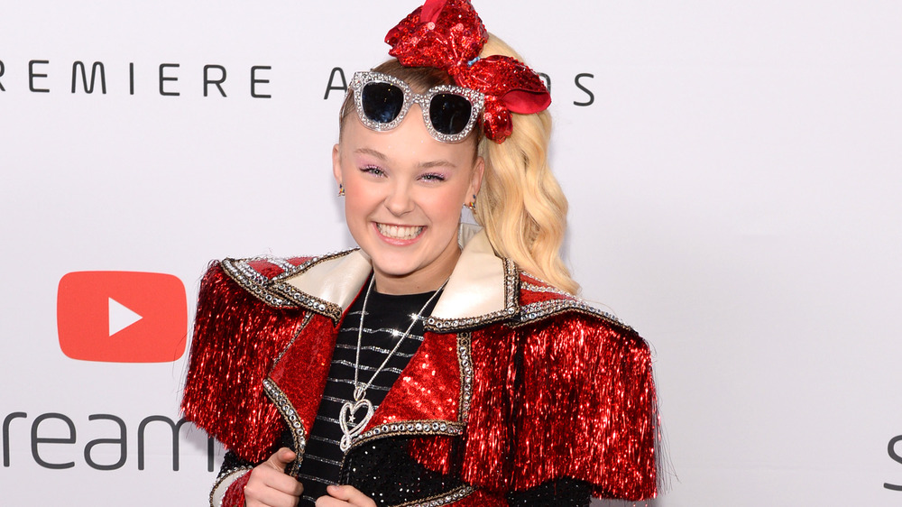 Jojo Siwa wearing red sparkly outfit