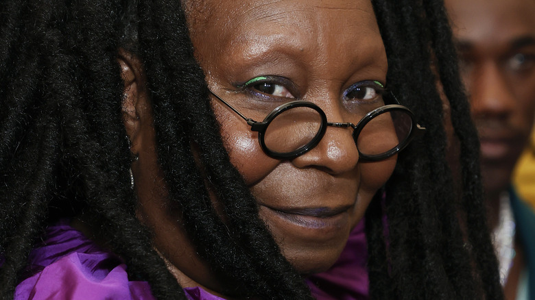 Whoopi Goldberg smiling and wearing glasses