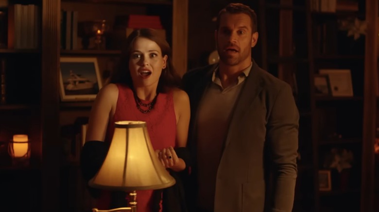 Joceyln Hudon and Stephen Huszar reacting to something in a scene from Christmas Wedding Planner (2017)
