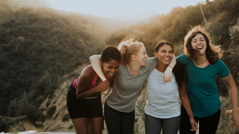 Multicultural women laughing on a mountain