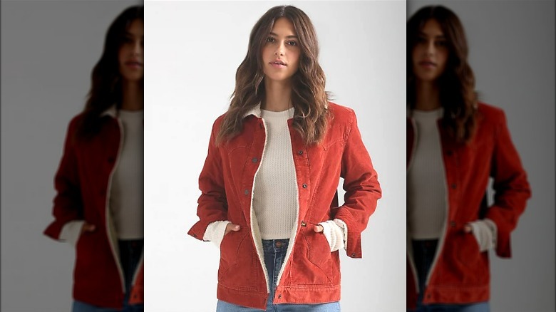 Model wearing rust colored corduroy jacket 