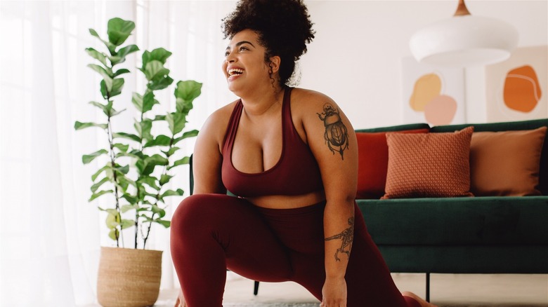 Smiling woman doing yoga at home