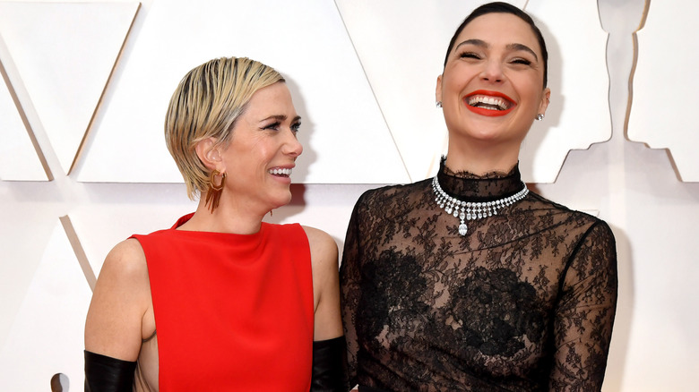 Gal Gadot and Kristin Wiig laughing on the red carpet