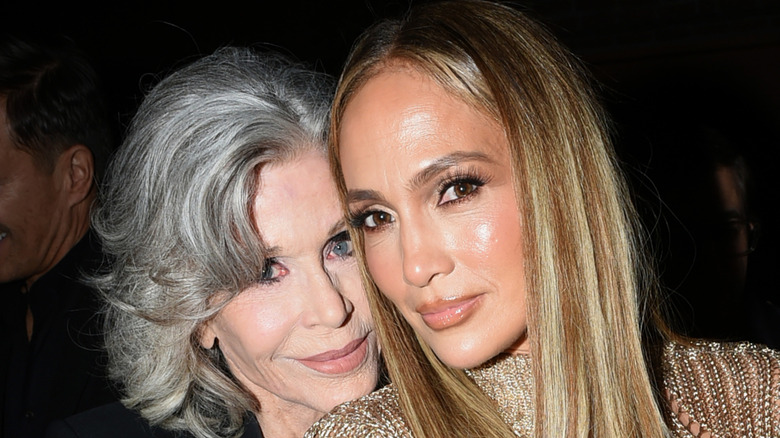 Jane Fonda with her head on Jennifer Lopez's shoulder