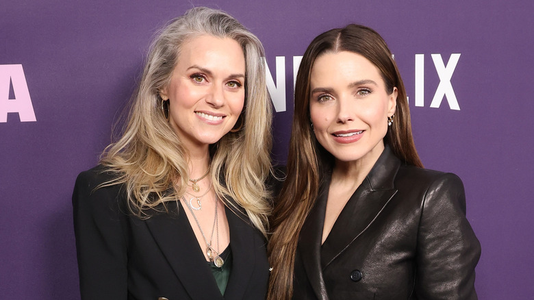 Hilarie Burton Morgan and Sophia Bush posing at an event