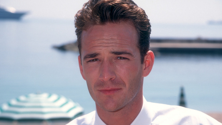 A young Luke Perry by the beach