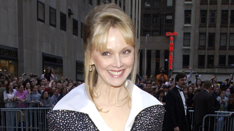 Shelley Long smiling at an event with crowds behind her