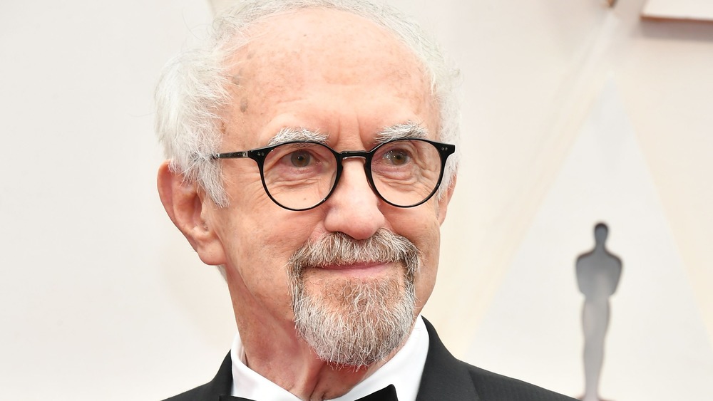 Jonathan Pryce wearing glasses