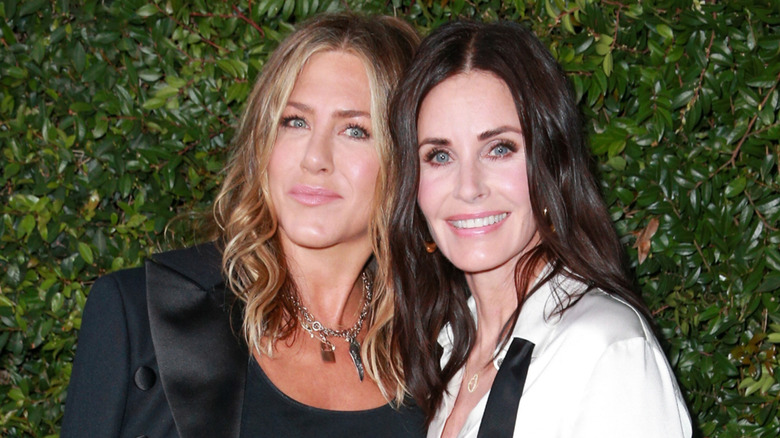 Jennifer Aniston and Courteney Cox posing at an event