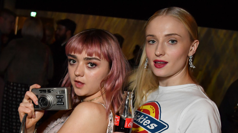 Sophie Turner and Maisie Williams posing with a camera