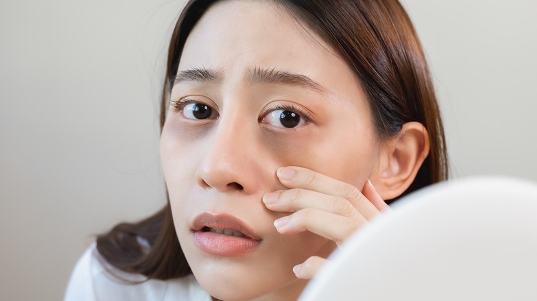 Concerned woman with dark circles beneath eyes