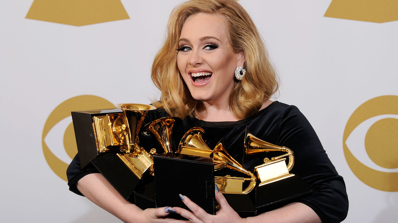 Adele posing with her Grammys