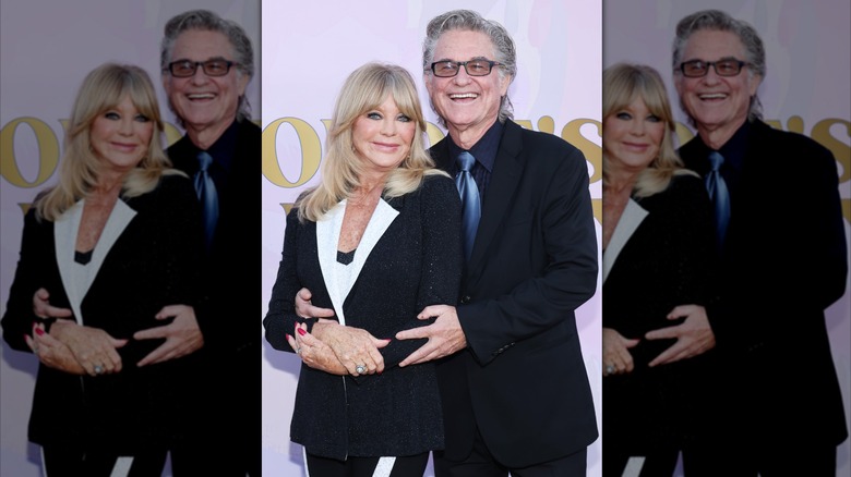Kurt Russell hugs Goldie Hawn