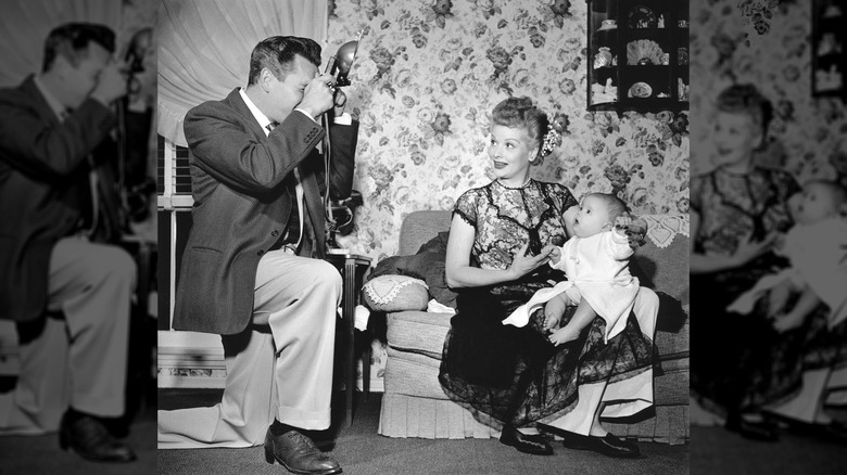 Desi Arnaz photographing Lucille Ball holding their son Desi Jr., California, January 1953.