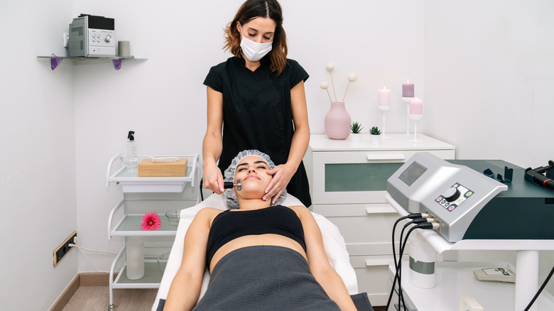 Aesthetician giving woman a treatment