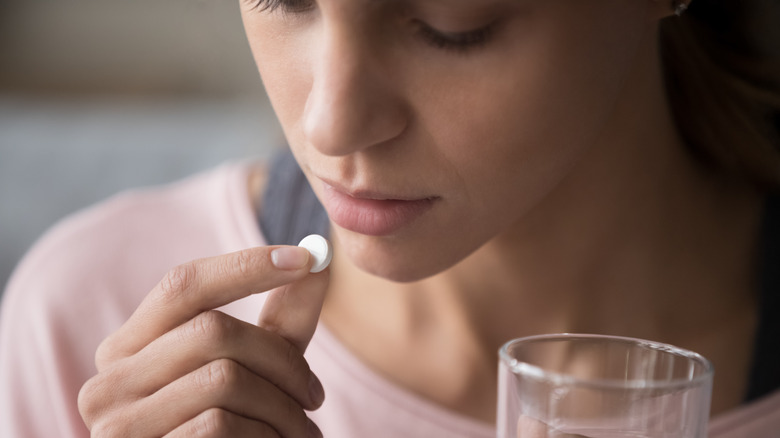 woman taking pill