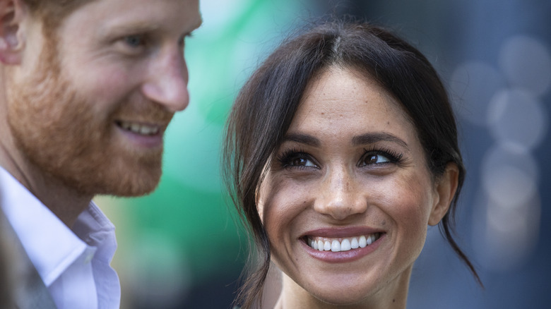 Meghan Markle smiling up at Prince Harry