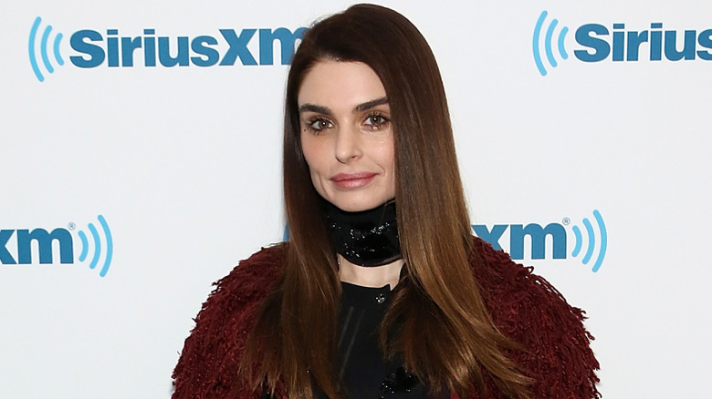 image of Aimee Osbourne smiling on the red carpet of an event