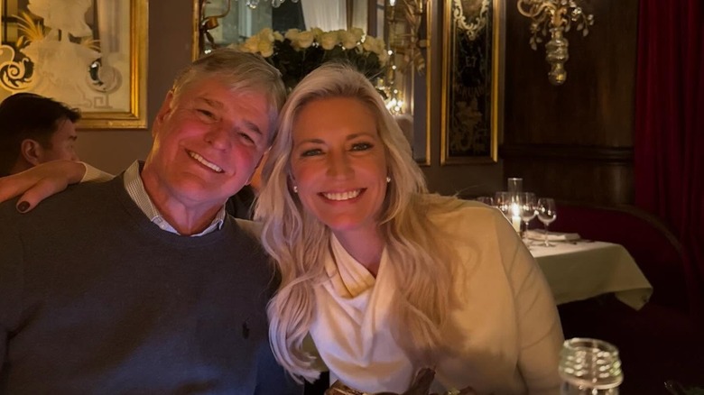 Sean Hannity and Ainsley Earhardt smiling in a Paris restaurant