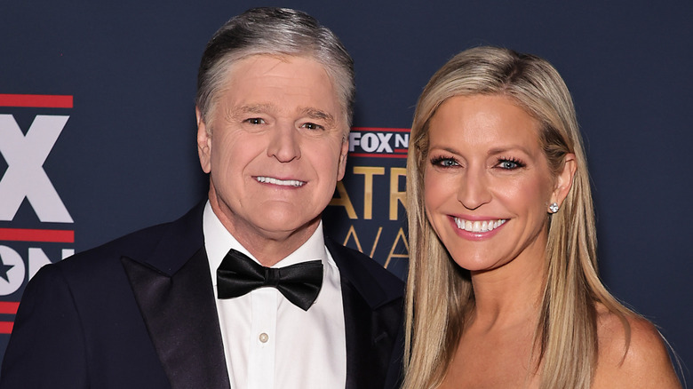 Sean Hannity and Ainsley Earhardt smile at an event