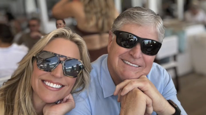 Ainsley Earhardt smiles next to Sean Hannity