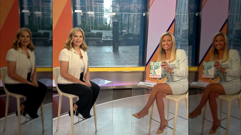 Ainsley Earhardt smiling next to Victoria Osteen while holding a book.