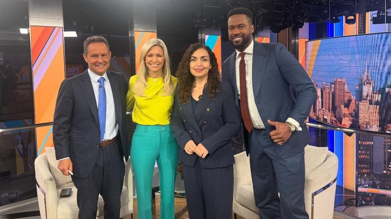 Ainsley Earhardt smiling with a group of people