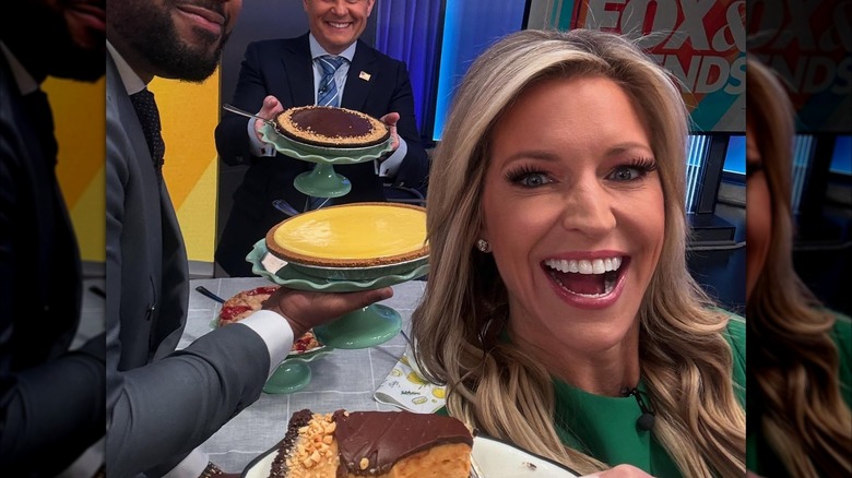 Selfie with Ainsley Earhardt posing with two men and pies.