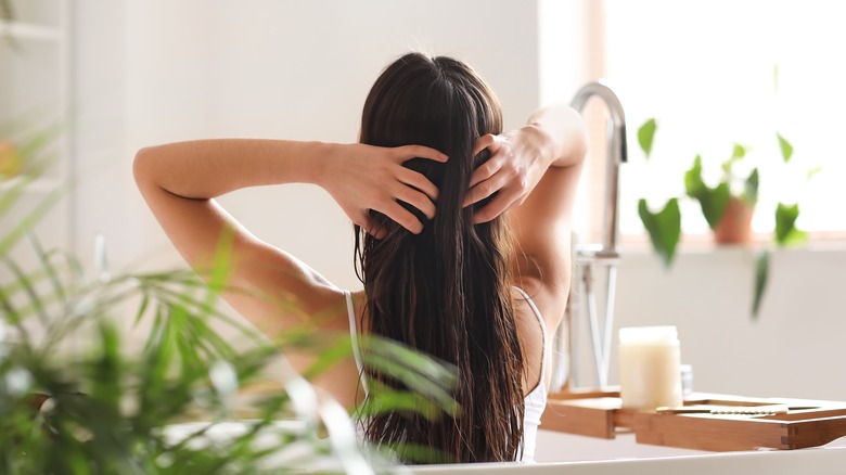 woman applying hydrating cream hair