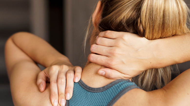 Woman rubbing her neck