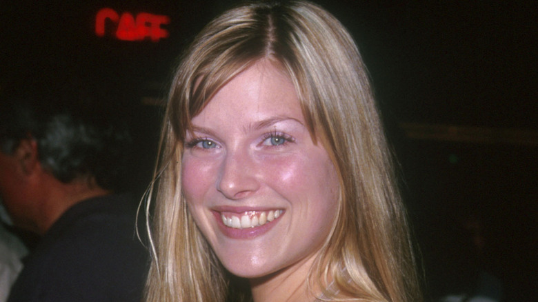 Ali Larter smiles with her hair parted to the side