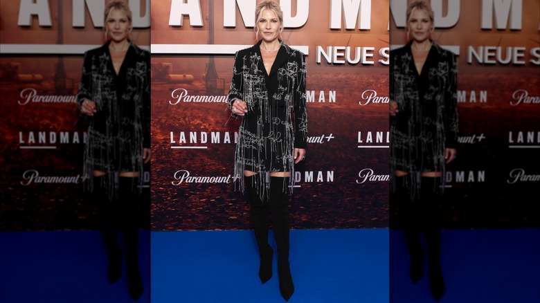 Ali Larter wearing beaded blazer and high boots