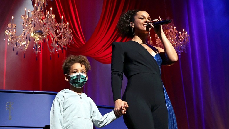 Genesis Dean and Alicia Keys holding hands