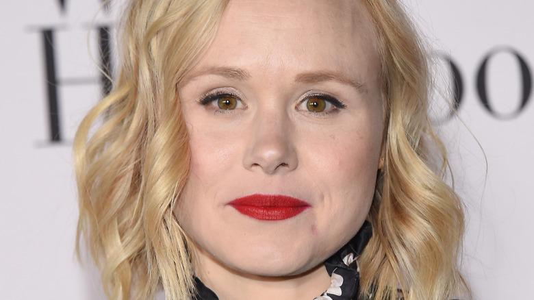 Alison Pill wearing polka dot top and red lipstick
