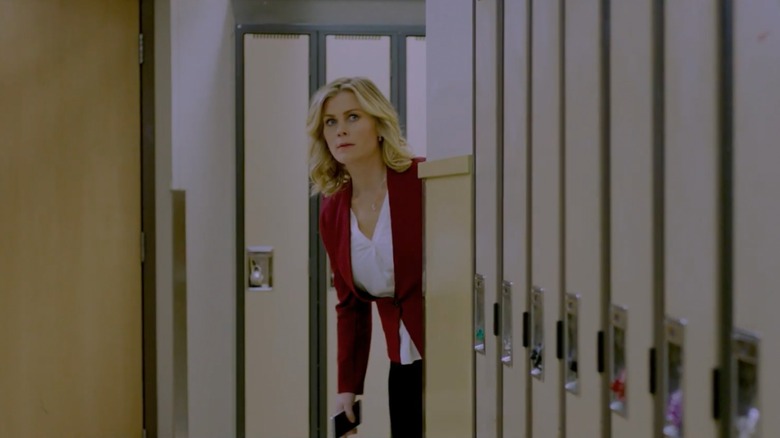 Alison Sweeney peeking around the corner in a hallway of lockers