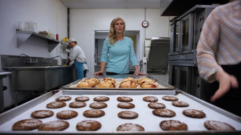 Alison Sweeney looking fearfully over trays of baked goods