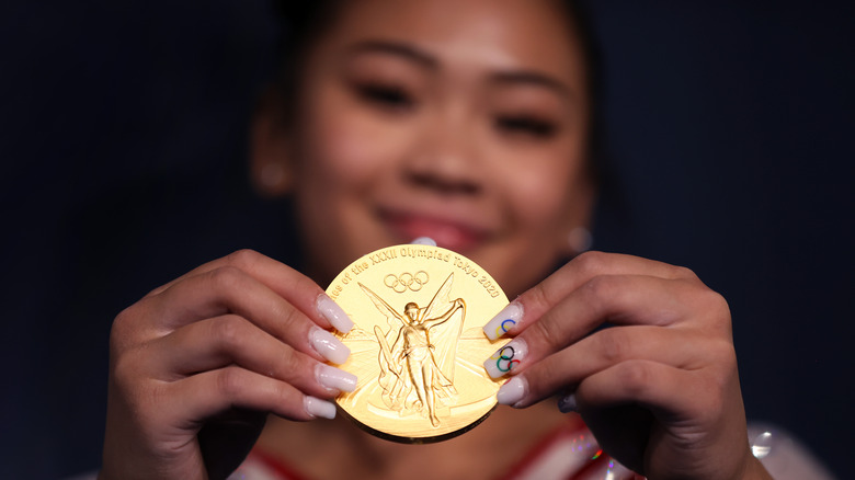 Suni Lee shows off gold metal and Olympic printed nails