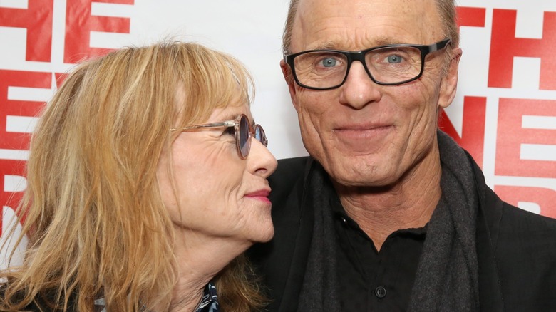 Amy Madigan looking up at Ed Harris and smiling
