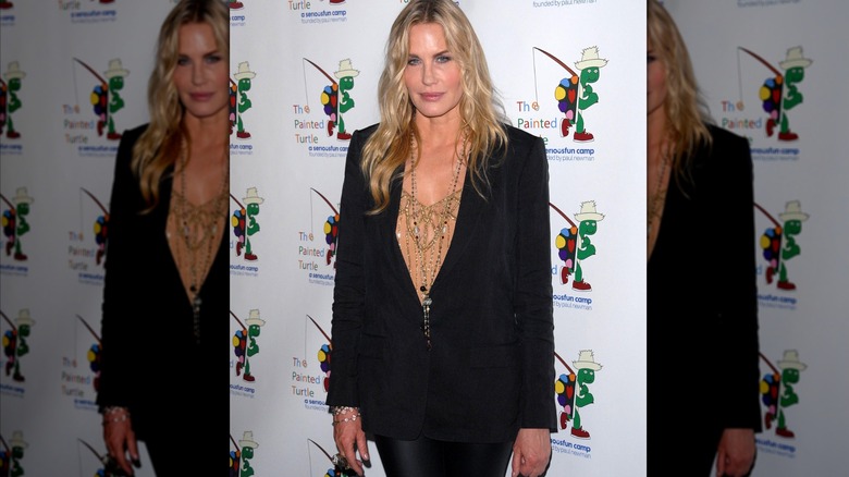 Daryl Hannah in black blazer with long necklaces